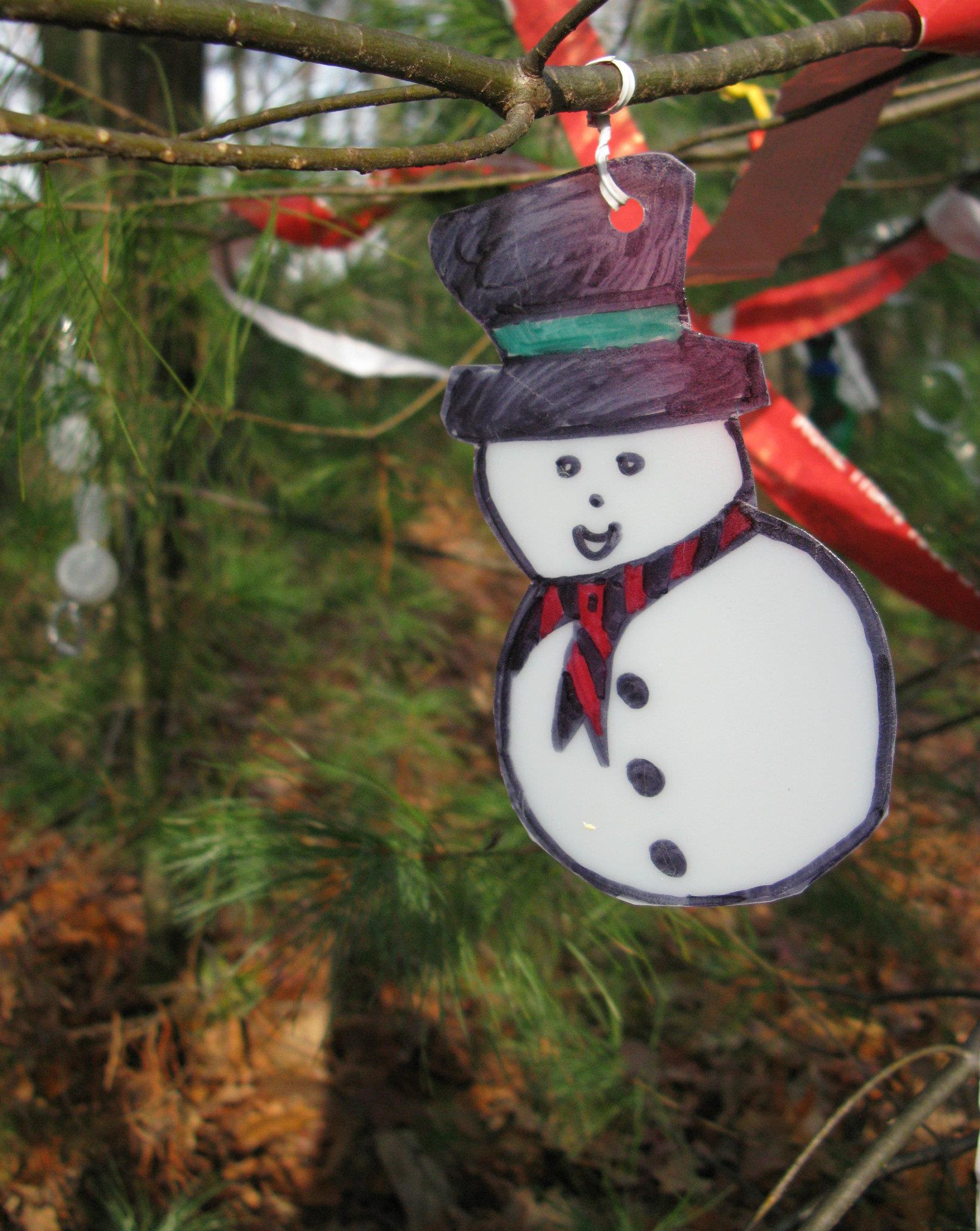 snowman-ornament A snowman ornament mad from recycled materials hung on one of the scavenger hunt trees in past years